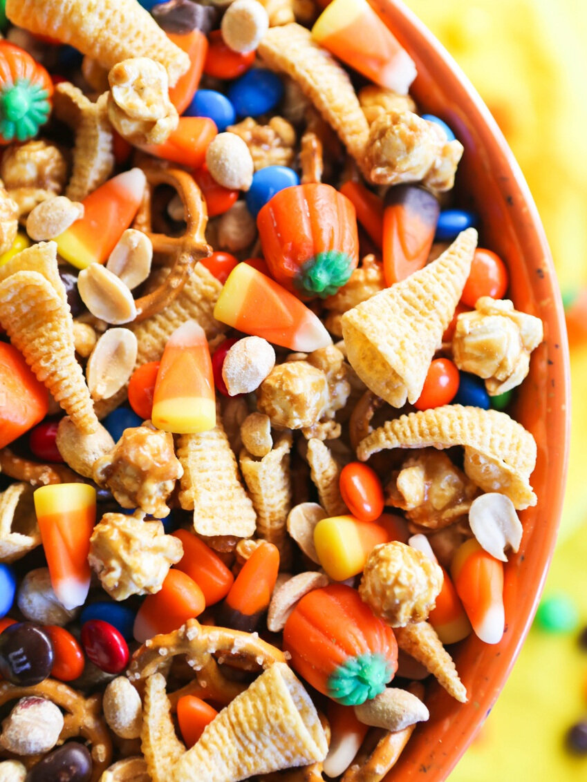  close of halloween snack mix in orange mixing bowl 